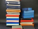 several books stacked on top of each other on a table