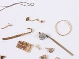 many different types of jewelry on a white surface