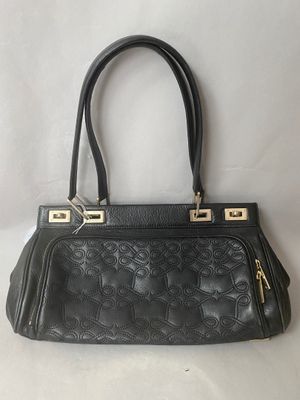 a black handbag with gold hardware on the handle