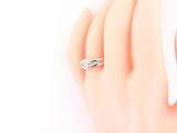 an image of a woman ' s hand with a ring on it