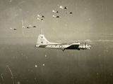 a lot of planes flying in the sky with smoke coming out of them