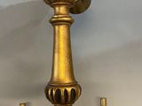 brass plated chandelier with a bird on top of it