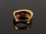 an 18k gold ring set with sapphires and diamonds