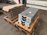 a stack of metal boxes on a pallet in a garage