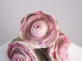 three roses that are sitting on a white plate