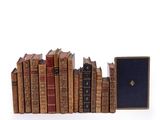 a lot of books that are stacked on top of each other