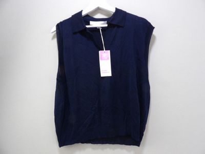 a close up of a shirt on a hanger on a wall