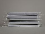 three stacks of books wrapped in plastic sitting on top of a table