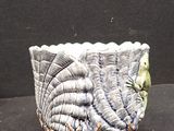 a ceramic bowl with a bird on it sitting on a table
