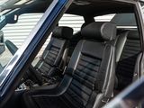 a picture of the inside of a car with black leather seats