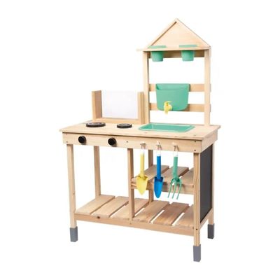 a wooden workbench with a green bucket and tools on it