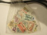 a bag filled with postage stamps on a string