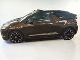 the brown car is parked on the white floor in the room