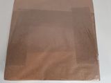 a brown paper bag sitting on a white table