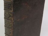 an old book sitting on top of a table next to a white background