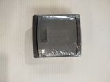 a small black object that is on a white surface