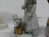 a figurine of a woman and a cat on a table