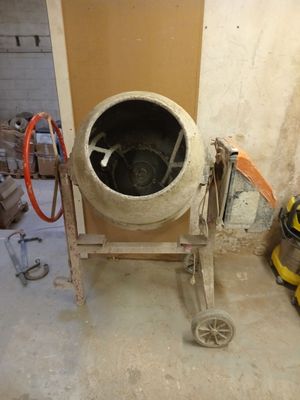 a cement mixer sitting in the corner of a room