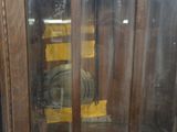 a glass display case with a clock inside of it