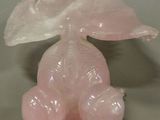 a pink elephant figurine sitting on a table