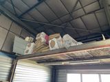 many bags of food on a metal shelf in a warehouse