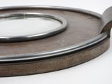 a silver plate with a mirror on it on a white surface