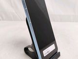 a phone that is sitting on a stand on a table