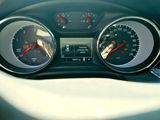 a close up of a car dashboard with various gauges