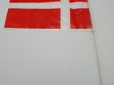 flag of denmark on a stick on a white surface