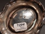 a silver vase with a label on it