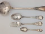 five spoons and a fork sitting on a table