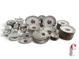 a pile of china plates and bowls on a white surface