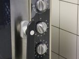 a silver oven with a black door in a kitchen