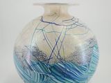 a glass vase with a blue and white design on it