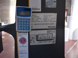 a calculator sitting on the side of a parking meter