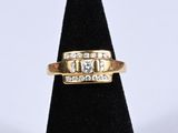 a close up of a gold ring with diamonds on it