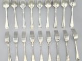 a lot of silver spoons and forks on the table