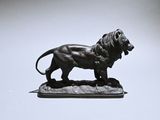 a statue of a lion that is standing on a table