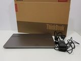 a laptop computer sitting on top of a table next to a box