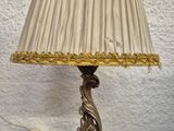 a lamp that is sitting on a table with a lamp shade on it