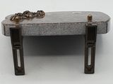a small bench with a chain on it on a white surface