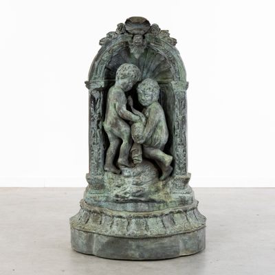 statue of a boy and a girl in a niche on a pedestal