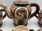 a tea set with a cup and saucer on the table