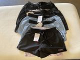 three pairs of men ' s boxer shorts sitting on a bed