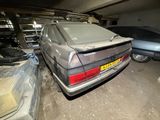 a car that is parked in a garage with other cars