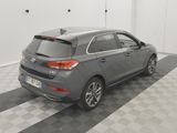 the back end of a grey car parked in a garage