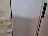 a white refrigerator with a yellow sticker on it
