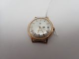 an image of a watch on a white surface with a chain around it