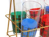 four glasses in a gold holder on a white background