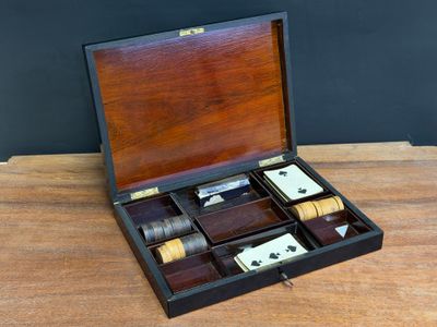 an old wooden box with four bottles of liquor in it on a table